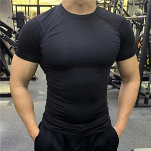 Detail view of mens black short sleeve compression fitness shirt, tight athletic gym training top.