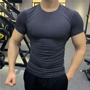 Detail view of mens quick dry fitness short sleeve tight compression t shirt for gym workout.