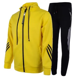 Detailed view of yellow hoodie and black sweatpants with three stripes and drawstring.