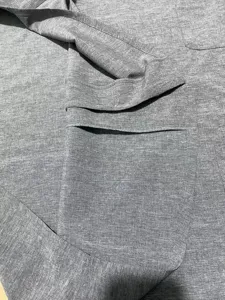 Close up detail of mens casual grey linen blend short sleeve shirt fabric texture and collar.