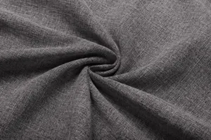 Grey cotton linen fabric close-up, showing detailed texture and soft material surface.