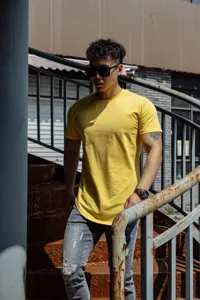 Detail view of men's solid yellow short sleeve t-shirt, muscle fit design for casual wear.