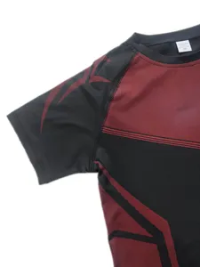 Detailed view of men's athletic compression shirt sleeve, black and red athletic gear.