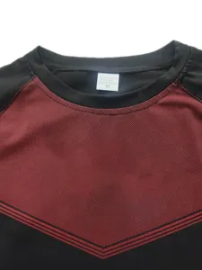 Men's athletic compression t-shirt detail showing fabric texture, crew neck and inner tag.