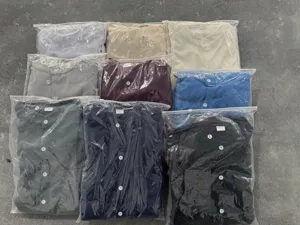 Detailed view of men's waffle knit henley shirts in various colors, neatly packaged in bags.
