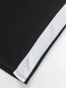 Close up view of mens waffle knit long sleeve top showing fabric detail and contrast side panel