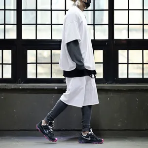 Detail view of the casual men's sportswear set, showing layered sleeve and stylish sneaker.