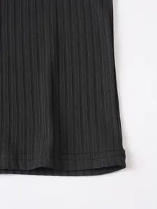 Close-up detail of mens black knitted ribbed tank top fabric hem showing fine texture.