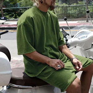 Detailed shot of men's casual summer short sleeve t-shirt and shorts streetwear outfit.