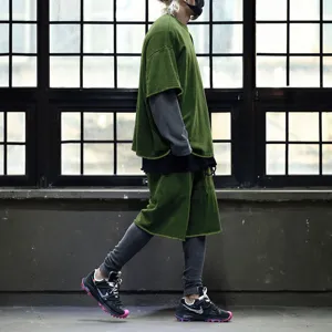Men streetwear layered short sleeve t-shirt and shorts outfit close up detail view