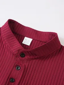 Detailed view of men's ribbed knit henley collar top in wine red with button closure.