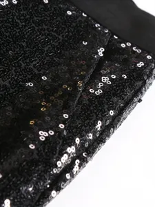 Close-up of black sequin men's formal trousers fabric detail, elegant texture view.