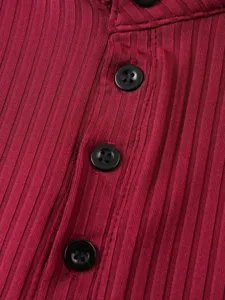 Close-up detail of knitted ribbed fabric with black buttons and neat placket stitching.