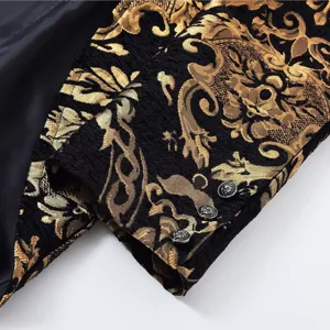 Detailed view of men gothic steampunk jacket sleeve featuring black gold brocade and metal buttons.