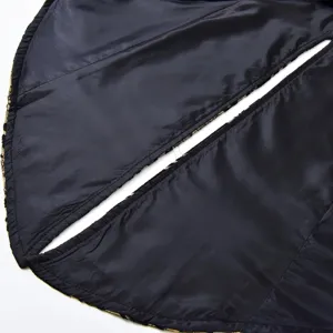 Detailed close-up view of black gothic steampunk tailcoat lining with brocade trim.