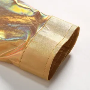 Gros plan détaillé du poignet de chemise doré métallisé brillant avec de fines coutures.