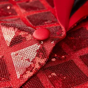 Close-up of red sequin men jacket lapel fabric detail showing sparkling square sequins.