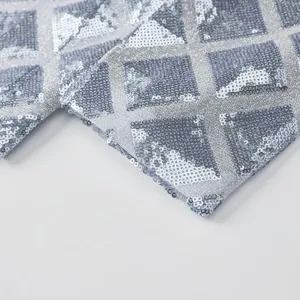 Mens silver sequin suit jacket fabric detail view showing sparkling geometric pattern.