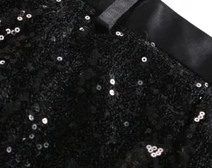 Men's sequin suit pants fabric detail closeup, elegant stage performance trousers texture.