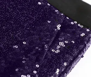 Purple sequin fabric close-up detail for stage performance wear and custom trousers.