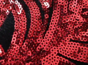 Detailed view of the red sequin fabric texture, showcasing the sparkling party suit material.