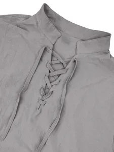 Grey linen stand-collar shirt detail, featuring a lace-up placket and long sleeves.