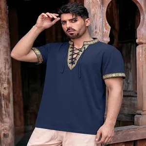 Detailed view of men's medieval renaissance pirate shirt in navy blue with gold embroidery trim.