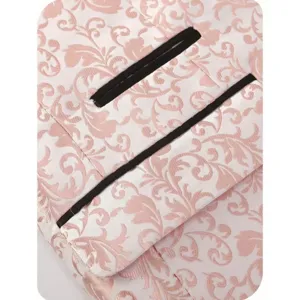 Detailed close-up view of pink floral jacquard suit jacket fabric with black pocket trim.