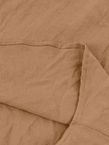 Close-up detail of khaki linen fabric texture and fine stitching for casual long sleeve shirt.