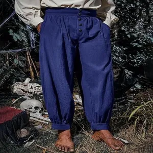 Detail of medieval pirate trousers, loose cotton linen cuffed design with front buttons.