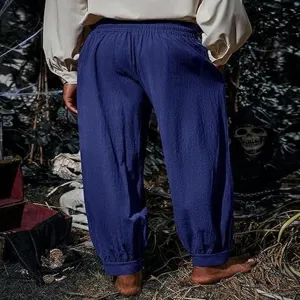 Detail view of loose cotton linen pirate pants in dark blue, medieval renaissance style.