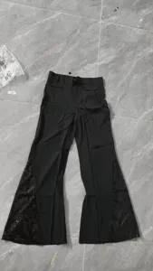 Vue détaillée du pantalon évasé noir doté de panneaux de sequins scintillants à l'ourlet.