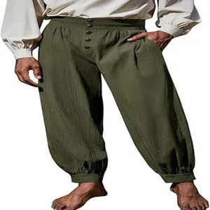 Detail view of the loose cotton linen cuffed trousers showing high waist and buttons.