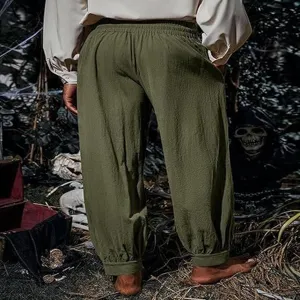 Detail view of men's vintage medieval pirate trousers in army green, comfortable cotton linen fabric.