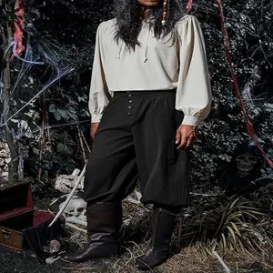Detail view of medieval renaissance men's cotton linen loose pirate pants with boots.