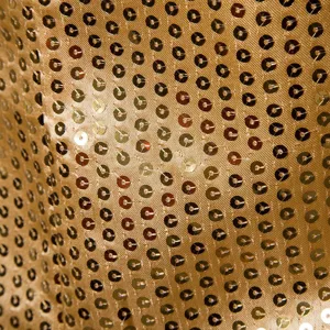 Gold sequin fabric detail close up for evening party dress apparel design texture style