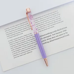 Detailed macro view of purple dried flowers floating in an oil-filled ballpoint pen