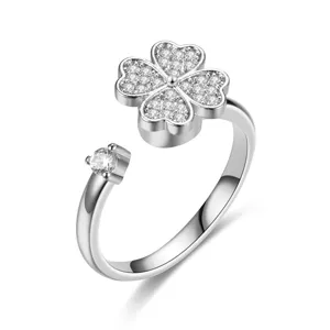 Close-up of rotatable four-leaf clover silver ring with sparkling crystal accents.