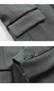 Men's grey suit jacket detail shot featuring contrast piping pocket and stylish sleeve buttons.