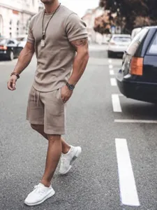 Street style men's casual two-piece tracksuit set in khaki, featuring short sleeve top and shorts.