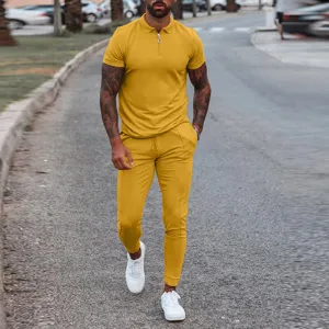 Outdoor street detail view of men yellow polo shirt and casual pants set, showing slim fit design.