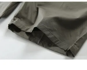 Detail view of men's jumpsuit pant cuff, fine stitching and durable olive green fabric.