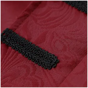 Detailed view of a vintage men coat fabric featuring elegant black braided trim on red texture.