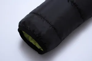 Herren Winter Daunenjacke Ärmel Detail, schwarze Außenhülle mit kontrastierendem grünem Innenfutter.