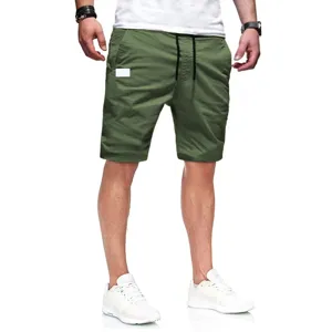 Detailed view of men's casual green shorts, lightweight woven fabric, comfortable summer wear.