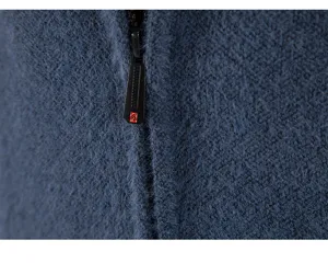 Close up detail of blue faux mink fleece cardigan zipper and soft knitted fabric.