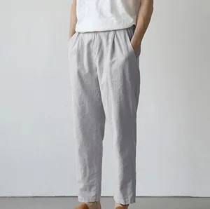 Detail view of men's casual trousers in light gray, comfortable fit for spring and summer.