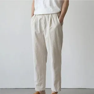 Men casual linen trousers detail view in beige color, comfortable elastic waist fit.