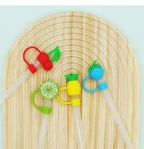 Cute fruit silicone straw covers detail close-up showing cherry lemon pineapple blueberry designs.