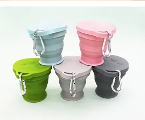 Portable silicone collapsible travel cup with cat paw lid and carabiner hook for outdoor use.